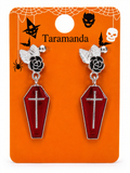 A pair of gothic coffin dangle earrings with black rose and silver bat details, displayed on an orange Halloween-themed card labeled 'Taramanda'.
