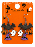 A pair of Halloween-themed bat drop earrings displayed on an orange backing card. Each bat-shaped earring hangs a pumpkin, a white ghost, and a purple witch hat charm.