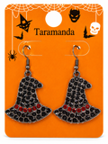 A pair of witch hat shaped drop earrings with black rhinestones and a row of red rhinestones, displayed on an orange Halloween-themed card labeled 'Taramanda'.
