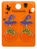 A pair of Halloween-themed drop earrings on an orange display card. The earrings feature purple witch hats with multicolor rhinestone trim and orange cauldrons with green crystal-like accents.