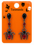 A pair of Halloween dangle earrings on an orange retail display card. The earrings have black faceted teardrop top stones, small red round stones, and silver spider charms with large red teardrop stones.