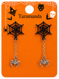 A pair of Halloween-themed dangle earrings displayed on an orange backing card. The earrings feature black spiderweb tops with small black spider charms at the bottom, connected by silver-toned chains.