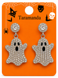 A pair of silver-toned ghost drop earrings covered in clear rhinestones, displayed on an orange Halloween-themed card with the brand name 'Taramanda'.