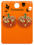 A pair of Halloween pumpkin stud earrings on an orange card. The earrings have gold-toned metal frames set with red and clear rhinestones, with green stems.